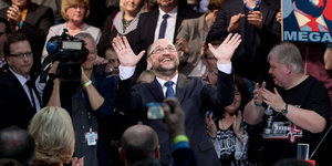 Umringt von Menschen hebt Martin Schulz beide Hände hoch