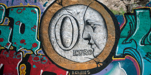 Ein Grafitti zeigt eine Euro-Münze, auf der eine Null steht