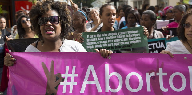 Frauen demonstrieren in Santo Domingo für ihr recht auf Abtreibung - mit pinken Bannern und passendem Hashtag