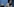 Ezzat Yaacoub Ishak steht vor einer blauen Wand in einem Appartment