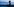 Ein Junge steht im Abendrot am Strand