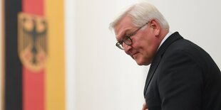 Frank-Walter Steinmeier neben einer Deutschlandfahne