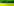 Ein Hochspannungsmast steht genau auf der Grenze zwischen einen gelbfarbigen Rapsfeld und einem mit grünen Pflanzen bewachsenem Acker