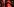 Katja Kipping und Bernd Riexinger vor einer roten Wand