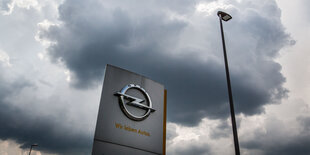 Das Opel-Logo unter dunklen Wolken