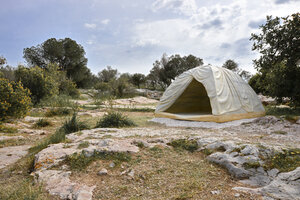 In einer Karstlandschaft steht ein Iglu-Zelt aus Marmor.