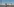 Vor strahlend blauem Himmel steht das Atomkraftwerk Fessenheim und spiegelt sich im Wasser