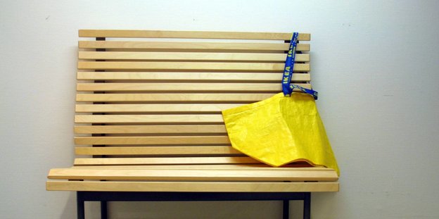 Eine leere gelbe Ikea-Tasche auf einer Bank