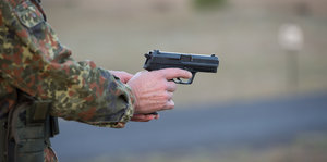 der Arm eines Bundeswehrsoldaten hält eine Schusswaffe