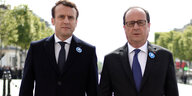 Emmanuel Macron und Francois Hollande gehen zusammen über einen Platz in Paris