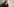 Offred (Elisabeth Moss) sitzt in einem roten Kleid und mit einem weißen Häubchen auf einem Sessel