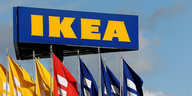 ein Schild mit der Aufschrift IKEA, darunter Flaggen mit selbiger Aufschrift