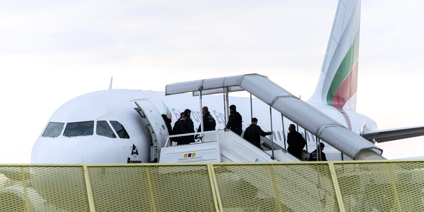 Menschen steigen in ein Flugzeug