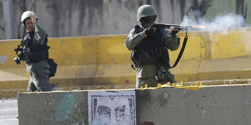 ein Mann in Uniform feuert ein Gewehr ab