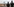 Polizisten stehen auf einer Straße und blicken auf einen Braunkohletagebau herab