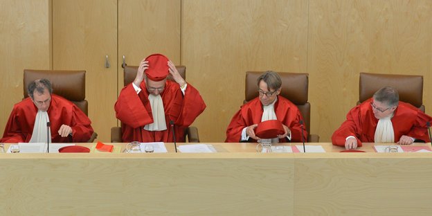 Vier Männer in roten Richterroben