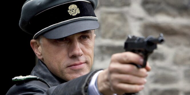 Der Schauspieler Christopher Waltz hält eine Pistole im Film Inglorious Basterds