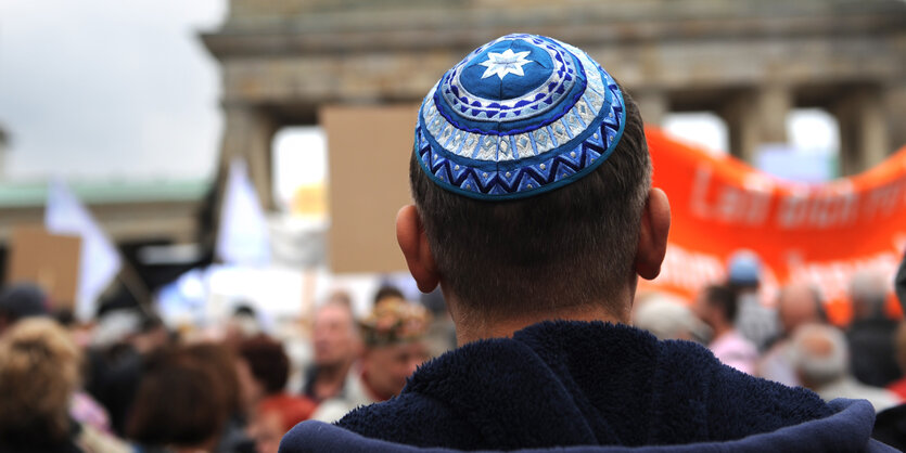 Ein Mann mit Kippa steht vor dem Brandenburger Tor