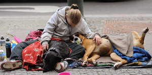 Eine junge obdachlose Frau schläft auf der Straße