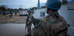 UN-Soldaten stehen neben einem Panzer