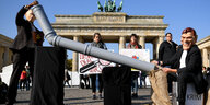 Zwei Menschen mit Putin und Schröder Maske demonstrieren vor dem Brandenburger Tor