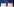 Hotelbett mit vielen Kissen vor blauer Wand