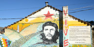 Eine Hauswand mit dem gemalten Portrait von Che Guevara