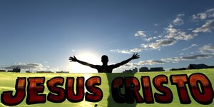 Ein Mann streckt hinter einem großen "Jesus-Christus"-Transparent die Arme aus.