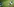 Rechts im Bild: zwei Fußballspieler im Kampf miteinander - Links im Bild: der Ball