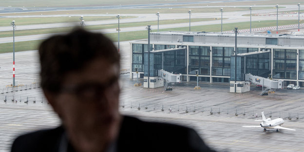 Die Silhouette eines Mannes vor einem Flughafen
