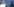 Frau mit blonden Haaren am Redepult, rechts ihr Schatten, dahinter blaue Tapete mit Aufschrift "AfD"
