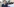 Eine Frau in Uniform neben der Fahrertür eines Polizeiautos
