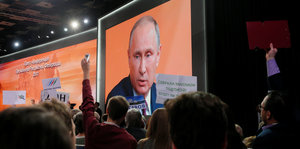 Das Gesicht Wladimir Putins auf einer Video-Leinwand
