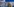 Eine Frau vor einem Aufsteller mit vielen Fotos