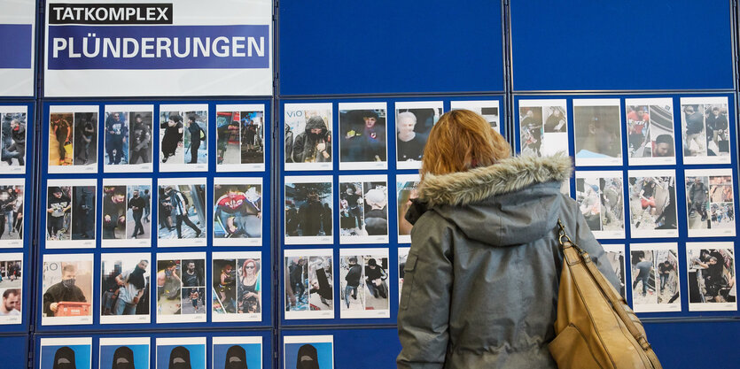 Eine Frau vor einem Aufsteller mit vielen Fotos