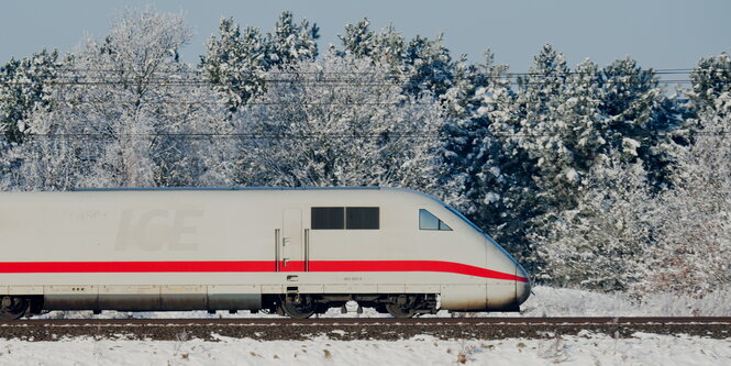 ein ICE fährt durch eine verschneite Landschaft