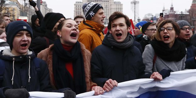 Junge Leute mit russischer Fahne laufen gemeinsam