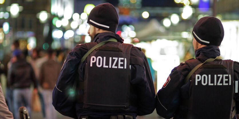 Zwei Polizisten in Uniform von hinten