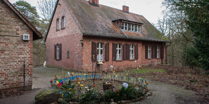 Das Steinhaus von Hans Lippert, davor eine Art rundes Beet