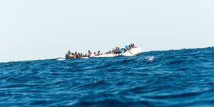 Ein Flüchtlingsboot treibt auf offenem Meer