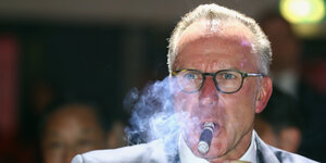 Bayern-Chef Karl-Heinz Rummenigge raucht eine Zigarre