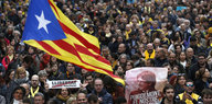 Demonstranten zeigen ein Transparent mit Puigdemonts Gesicht und die katalanische Flagge