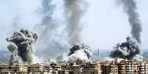 Rauch steigt nach dem Einschlag einer Rakete der syrischen Armee Anfang April über Duma auf.