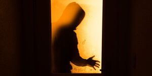 Schatten einer Person hinter einer Glastür