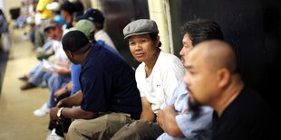 Mitglieder der vietnamesischen Community in Louisiana sitzen auf dem Boden bei einer Versammlung vom Ölkonzern BP.