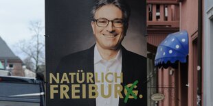 Ein Wahlplakat mit lachendem Mann darauf