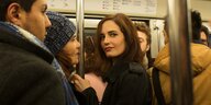 Ein Frau in der U-Bahn, die geheimnisvoll blickt
