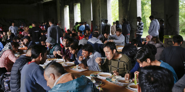 Viele Leute an einer Tafel Viele Leute an einer Tafel