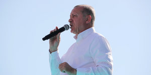 Recep Tayyip Erdogan spricht in ein Mikrofon