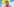Ebony Bones trägt eine blonde Perücke, in der sich verschiedene Spielzeuge befinden